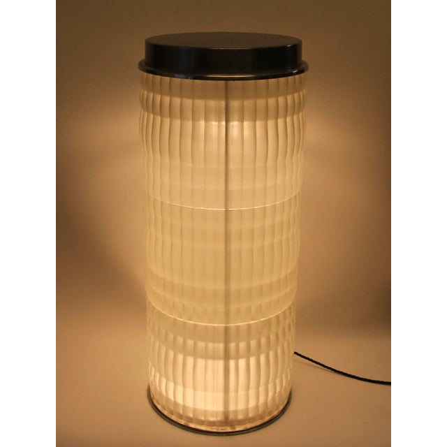 Exceptional floor lamp from HOLOPHANE, FRANCE. Glass cylinder. On iron base with aluminum cover. The cabling, including...