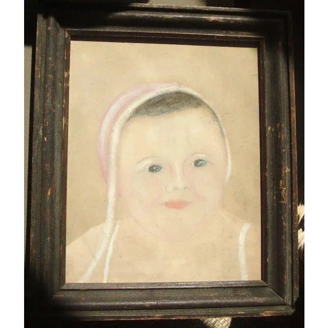 An exceptional folk art drawing of a young child framed under glass. Dates from the 19th century. I believe this is a...