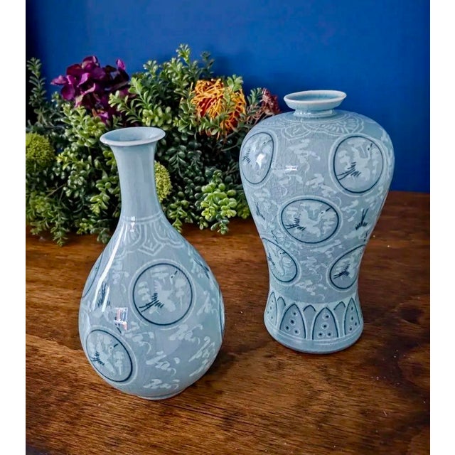 Elegant pair of vintage Korean celadon vases, each beautifully hand-painted with the traditional “Thousand Crane” motif —...