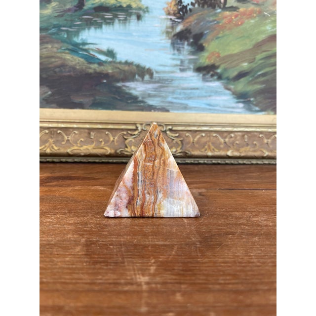 This solid onyx pyramid features finely polished surfaces and dramatic natural banding in tones of caramel, cream, rust,...
