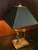 A vintage Frederick Cooper table lamp featuring three elongated golfers arranged across a stepped base, each captured at a...