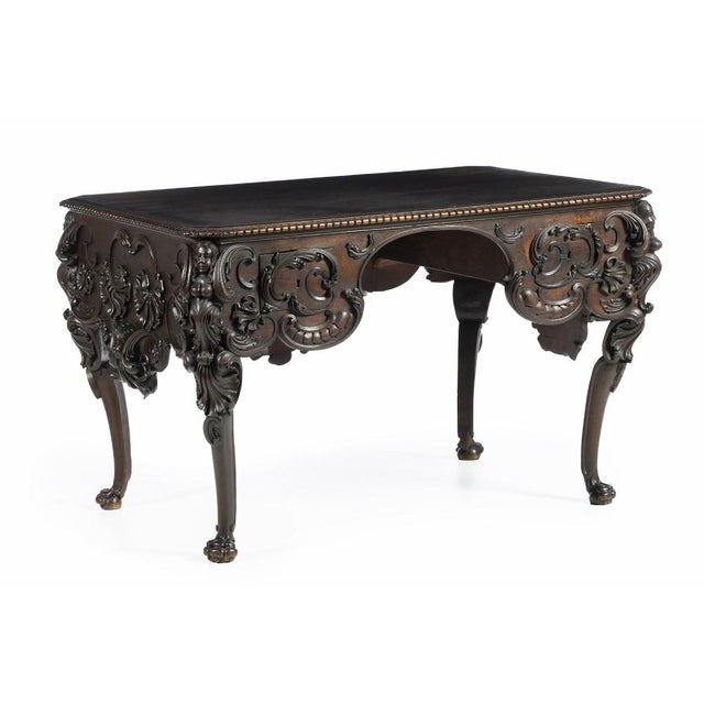 Amazing Portuguese Center Table 19th Century in chestnut wood with carvings, scalloped front, decorated with vegetal...