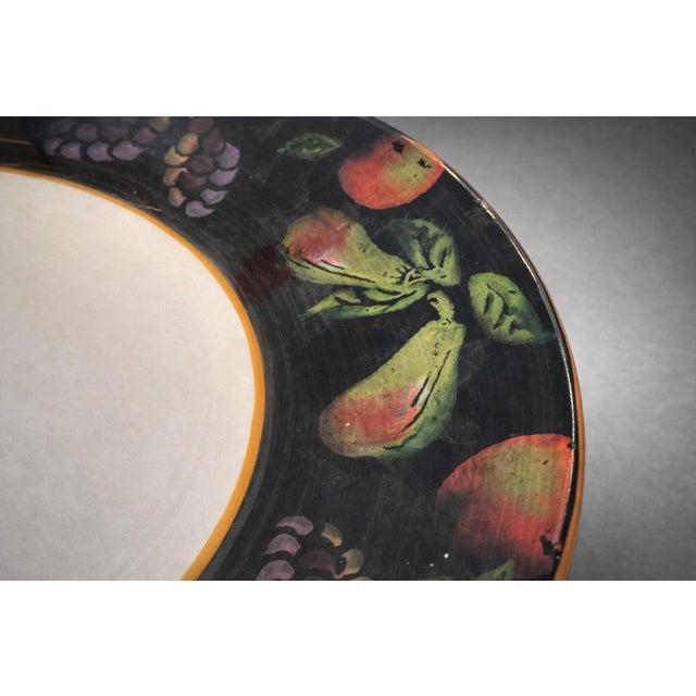 A striking hand-painted Italian ceramic charger by Ceramica ARM, featuring a richly painted fruit garland of pears,...