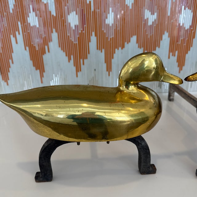 A pair of vintage andirons with brass ducks. Probably 1970’s and American. Ducks- 14 1/4” w x 3” d x 5 3/4” h