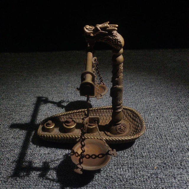 Add a touch of vintage scientific charm and Eastern mystique to your space with this exquisite brass balance scale....