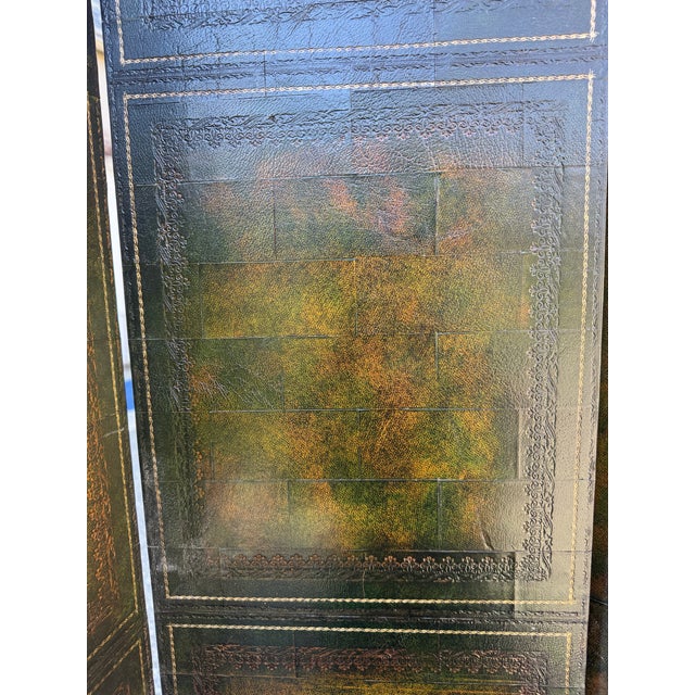 A beautiful leather bound library book four-panel folding screen/room divider by Maitland Smith, circa 1970s. The screen...