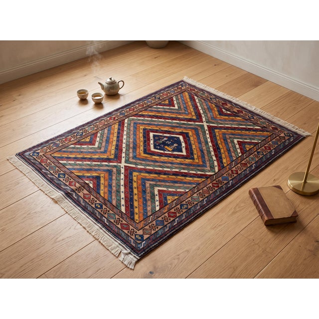 A radiant Sunburst Kazak design unfolds across this hand-knotted wool rug, its concentric diamond medallion built from...