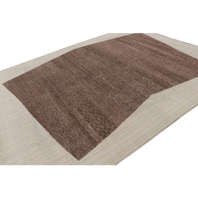 Hand-knotted in wool, this 9x12 modern rug, originating from India, as inspired by modern art with a geometric pattern, is...