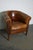 This vintage cognac-colored leather club chair comes from the Netherlands. It is upholstered with cognac-colored leather...