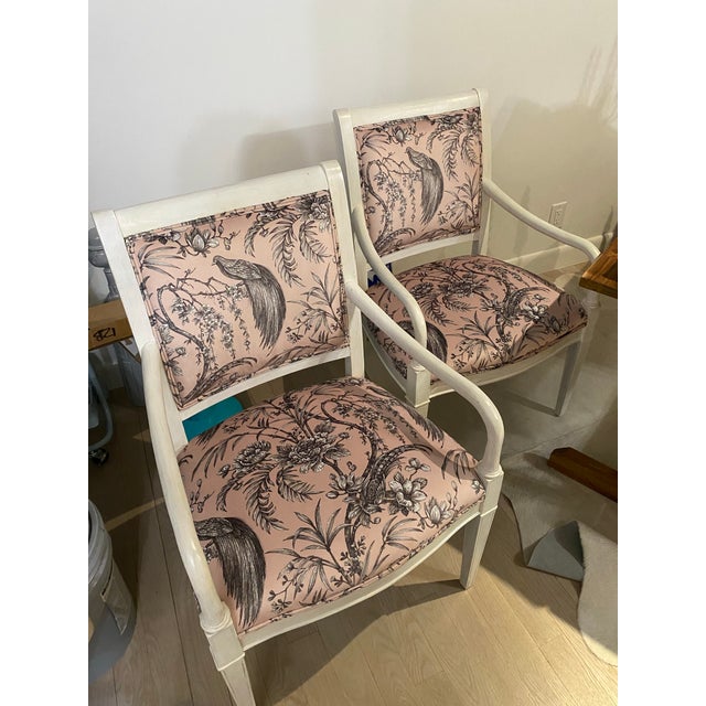 Two recently reupholstered wood chairs, wood painted with a white stain.