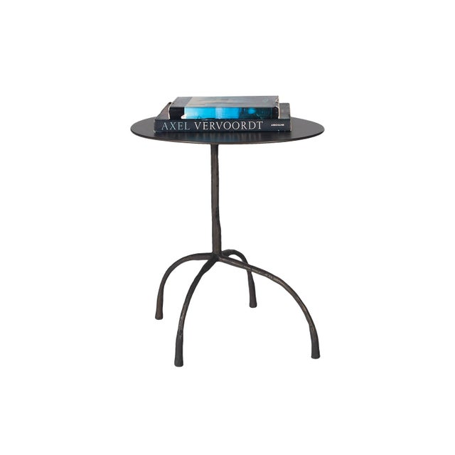 A striking accent piece that brings industrial character to any room. This side table features a rich patinated steel top...