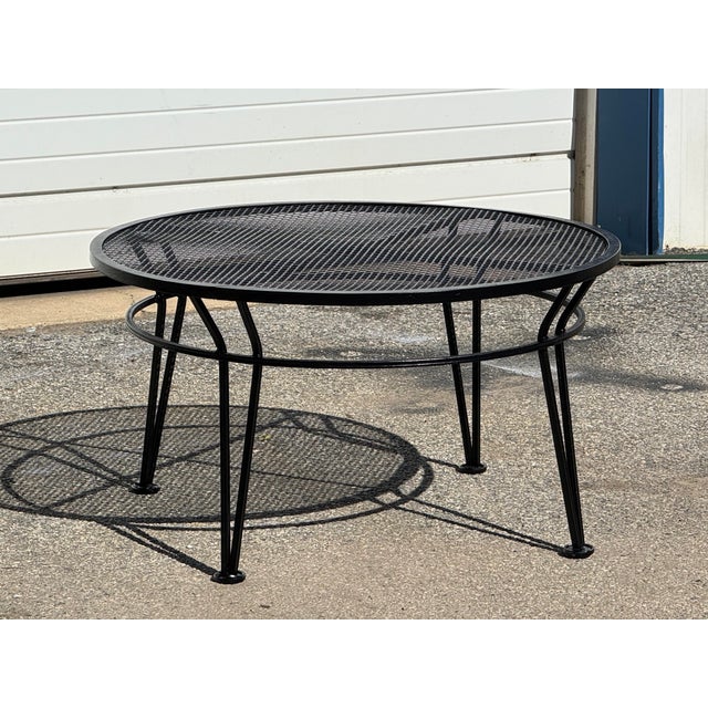 Offered is a Vintage Woodard Style Outdoor Wrought Iron Round Coffee Table. This classic patio tables features a black...