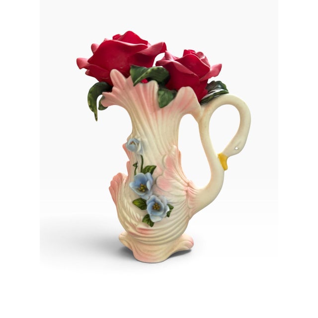 Striking vintage figural pitcher featuring an elegant swan form crowned with a dramatic bouquet of sculpted red roses. The...