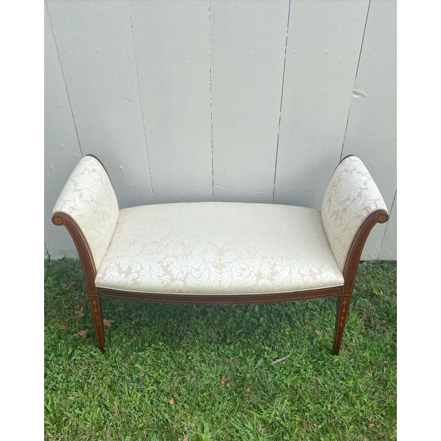 A beautiful and graceful Hepplewhite mahogany window seat/bench upholstered in a lovely neutral silk damask. This piece...