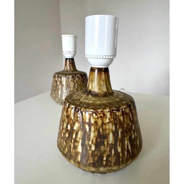 A very iconic, perfect matching pair of stoneware table lamps / lamp foots designed by Gunnar Nylund for Rörstrand sweden,...
