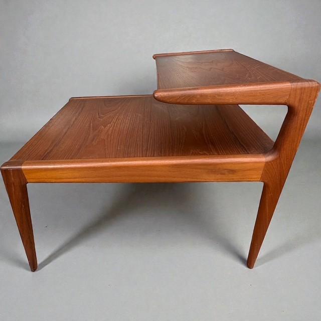 This rare two-tier teak end table was designed by renowned Danish designer Kurt Østervig and manufactured by Jason Møbler...