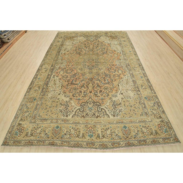 An authentic vintage traditional Tabriz rug hand-knotted with fine wool and natural dyes. This oriental rug features a...