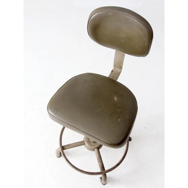 This 1970s All-Steel industrial stool exemplifies the clean, functional design of mid-century factory and drafting...