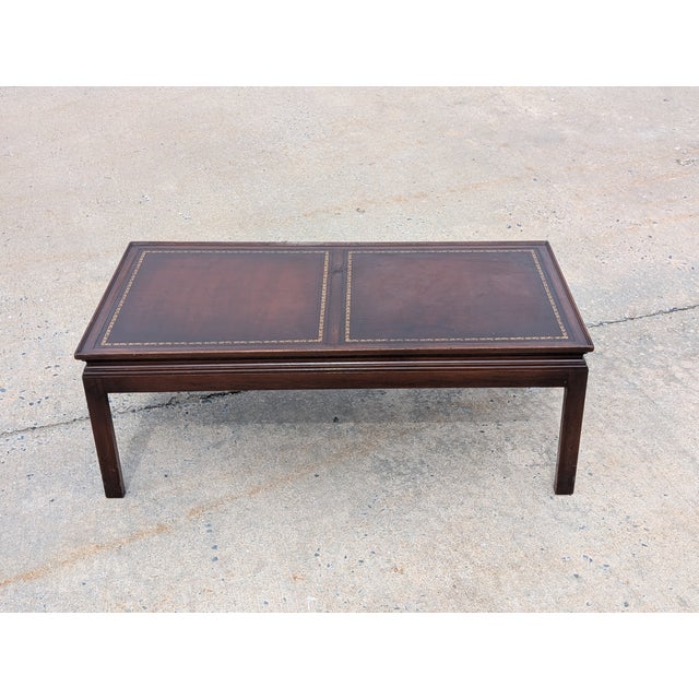 An exceptional find for the discerning collector, this mid-20th-century Federal style coffee table seamlessly marries...