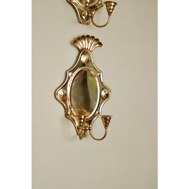 Made in Sweden Mid-century Swedish brass wall sconces, meticulously handcrafted with embossed designs, the sconce...