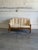 This architectural mid-size sofa features an organic open timber frame with structural cylindrical legs. Deeply stuffed...