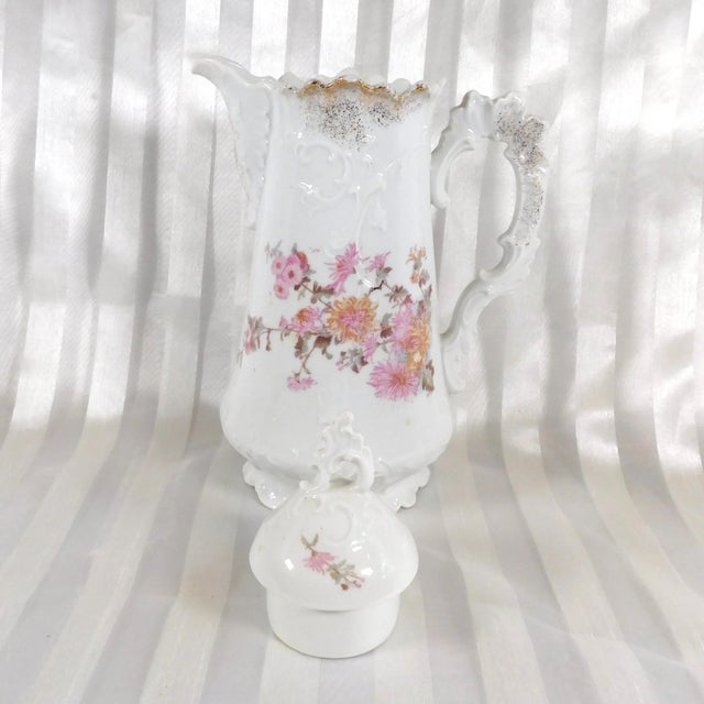 This is a white Brunswick Furstenberg chocolate pot in an unknown pattern. The chocolate pot has the Brunswick mark which...