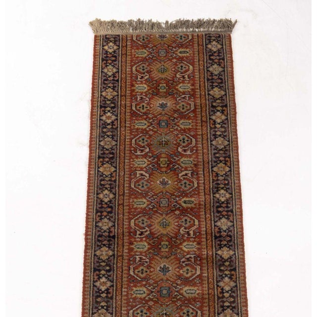 Persian Heriz Wool Runner, with geometric and floral motif on orange ground with fringe on the short sides. 8' 10" L x 2'...
