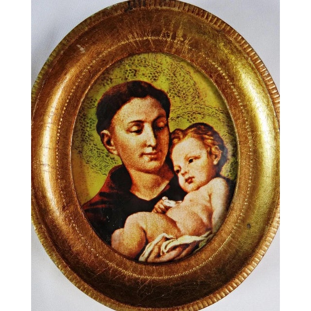Saint Anthony Holding the Infant Jesus in a Gold Leaf Frame Celebrate your faith with this holy image depicting the Patron...