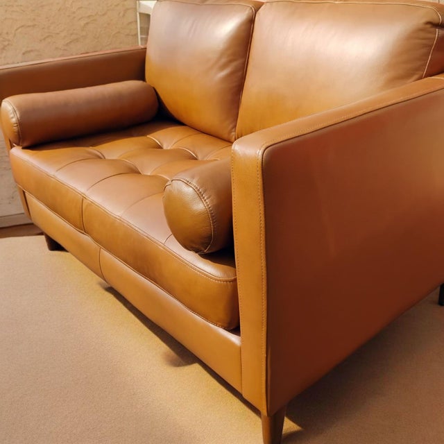 This loveseat epitomizes mid-century design refined for the modern home, featuring clean lines and a beautiful tan or...