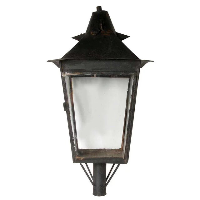 With a black, painted finish, this impressive antique tole lantern was hand crafted in traditional, lantern form; the...