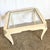A striking Postmodern side table showcasing sculptural lines and exquisite craftsmanship. The tessellated stone frame...
