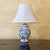 This charming vintage Chinoiserie-style table lamp features a classic blue and white porcelain ginger jar base decorated...