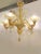 Classical transparent and amber Murano glass chandelier with flowers and leaves. Traditional piece of Italian art of...
