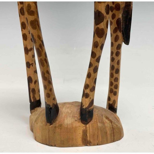 A striking piece of African folk art, this hand-carved hardwood giraffe stands approximately 23.5” tall and commands...