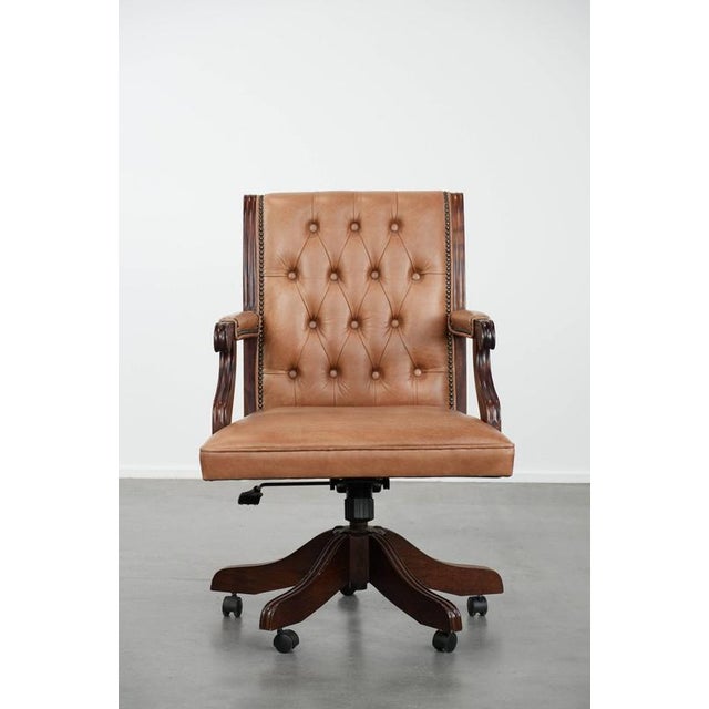 This attractive English-style, cowhide and wooden Chesterfield office chair is a timeless addition to any office. It...