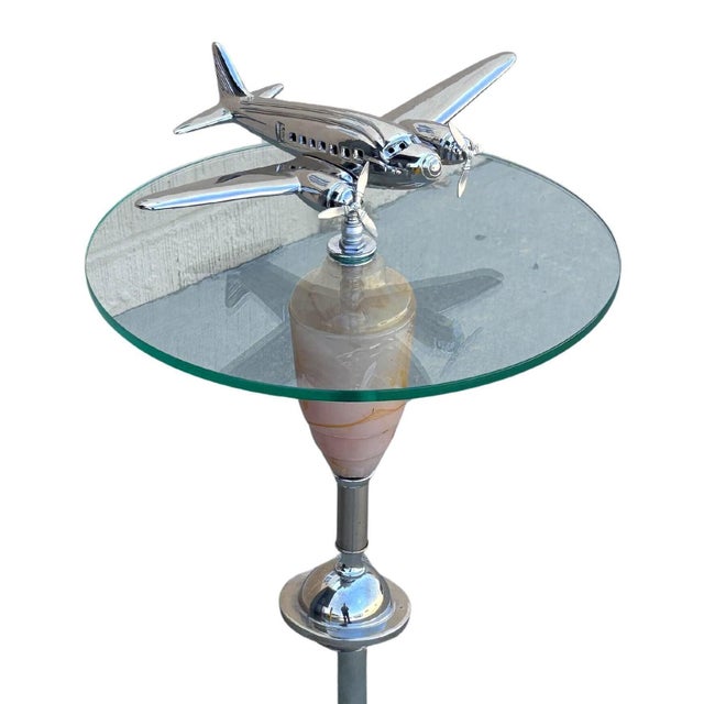 Art Deco chrome airplane round glass top side drinks table featuring a light-up art glass center with an additional light-...