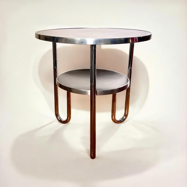An original piece of german design history, a design icon of 1930s bauhaus modernism: a loop-leg table made of chrome-...