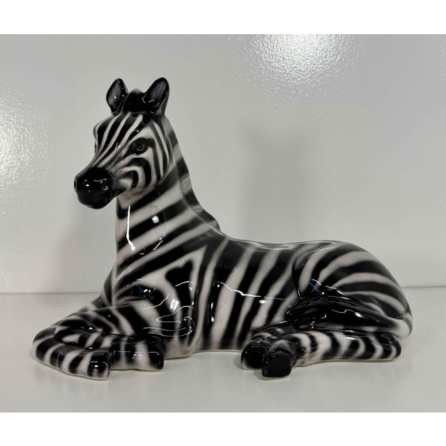 Elegant zebra sculpture produced in Bassano del Grappa, Italy. Hand-decorated in glazed ceramic, it features beautifully...