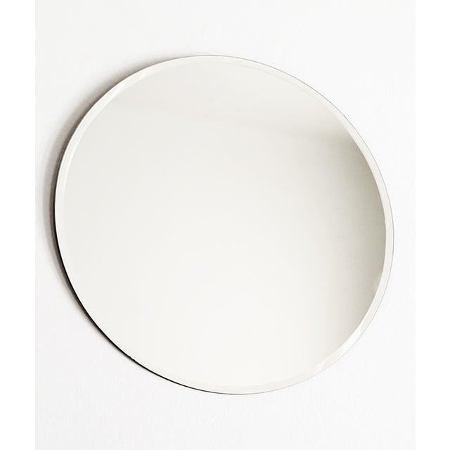 An elegant round vintage 1970s minimalist mirror with a facetted cut. This timeless design classic is 50 cm in diameter...