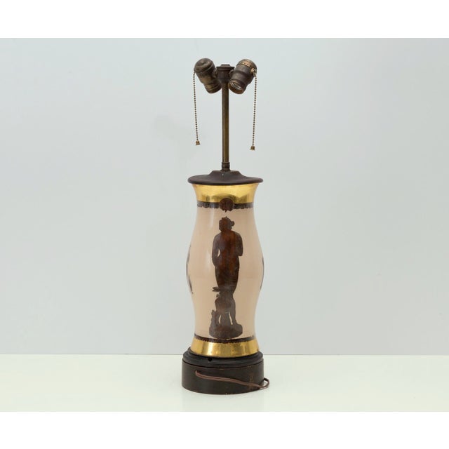 Very unusual and stately lamp featuring four classical Greek or Roman figures of different sizes. The figures are highly...