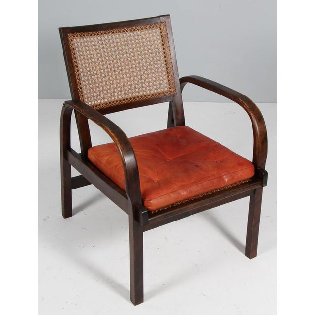 Magnus Stephensen Arm chair with frame of stained beech. Original patinated leather seat cushion. with the original cane...
