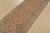 A tribal Caucasian Kazak runner hand-knotted with fine wool on a cotton foundation. This rug features a row of geometric...