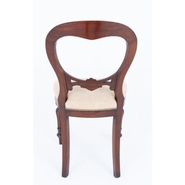 A handsome set of eight Victorian-style mahogany dining chairs, comprising six standard dining chairs and a pair of...