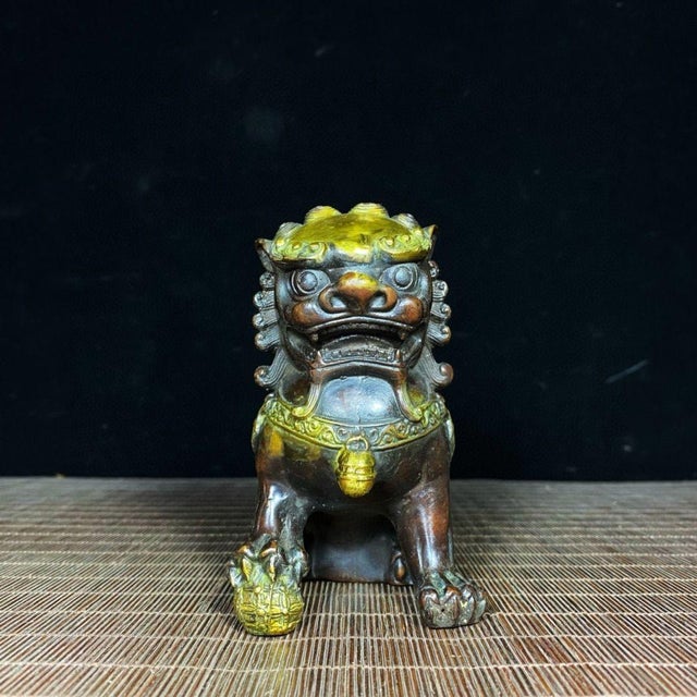 This is a matching pair of vintage gilt bronze guardian lions, also known as Foo Dogs. Each lion is finely cast with...