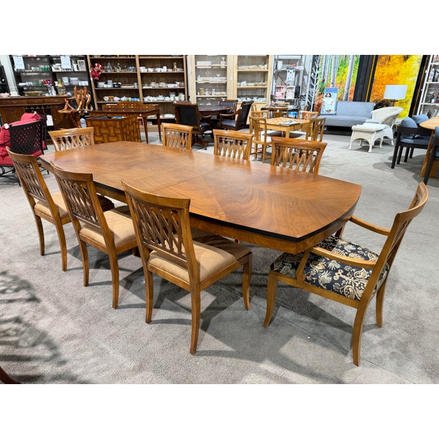 This Emerson Heirlooms dining table with eight coordinating chairs exemplifies classic American craftsmanship and timeless...