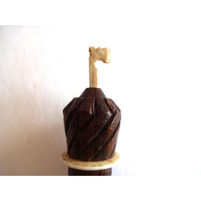 An antique French treen needle case in carved rosewood in the shape of a parasol or umbrella. Screw cap. 4" by 3/4". 19th-...