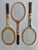 A charming set of three vintage Wilson wooden tennis racquets, each accompanied by its original wooden racquet press....