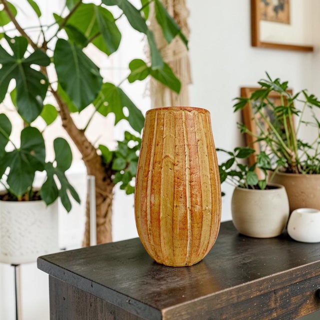 Elevate your home decor with this Rustic Orange Ceramic Fluted Texture Table Vase, a stunning piece that combines...