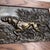 Elegant set of two antique bas-reliefs depicting hunting dogs, executed in dark-patinated bronze and framed in warm wooden...