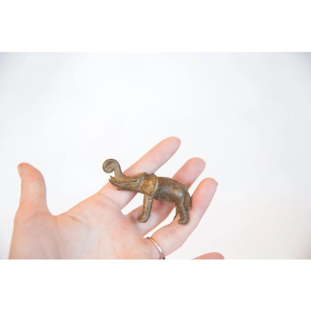 :: Vintage handmade bronze elephant with curled trunk. Circa mid 20th century and possibly older, this piece has such...
